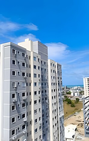 A multi-story building with a modern architectural design, featuring numerous windows and balconies. - 1503 Apto 2 Qtos completo João Pessoa (Cabedelo)