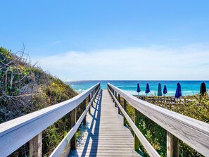 A wooden boardwalk leading to beach umbrellas. - Destin/Miramar Beach Escape, Family-Friendly + Private Beach Access (Destin)