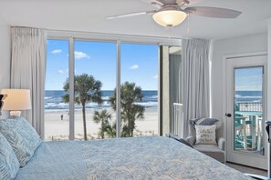 A bedroom with a large bed, a ceiling fan, and a view of the beach. - Beachside Haven - enjoy 3 beachfront bedrooms, 2nd floor, free beach chairs (Panama City Beach)