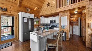 A cabin-style kitchen with a granite countertop, stainless steel appliances, and a wooden ceiling. - Smoky Mountain Views • Hot Tub • Fireplace • Cozy Cabin (Sevierville)