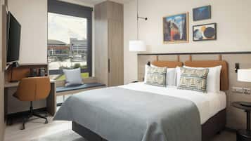 A modern hotel room with a large bed, a desk with a chair, a TV, and a view of the city.