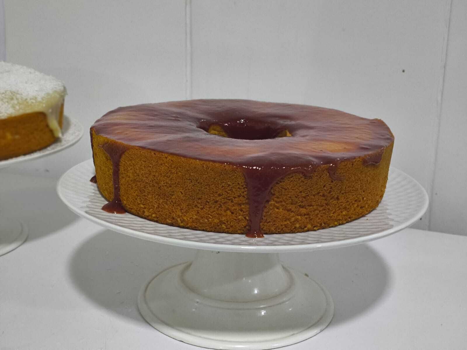 A cake on a white cake stand.