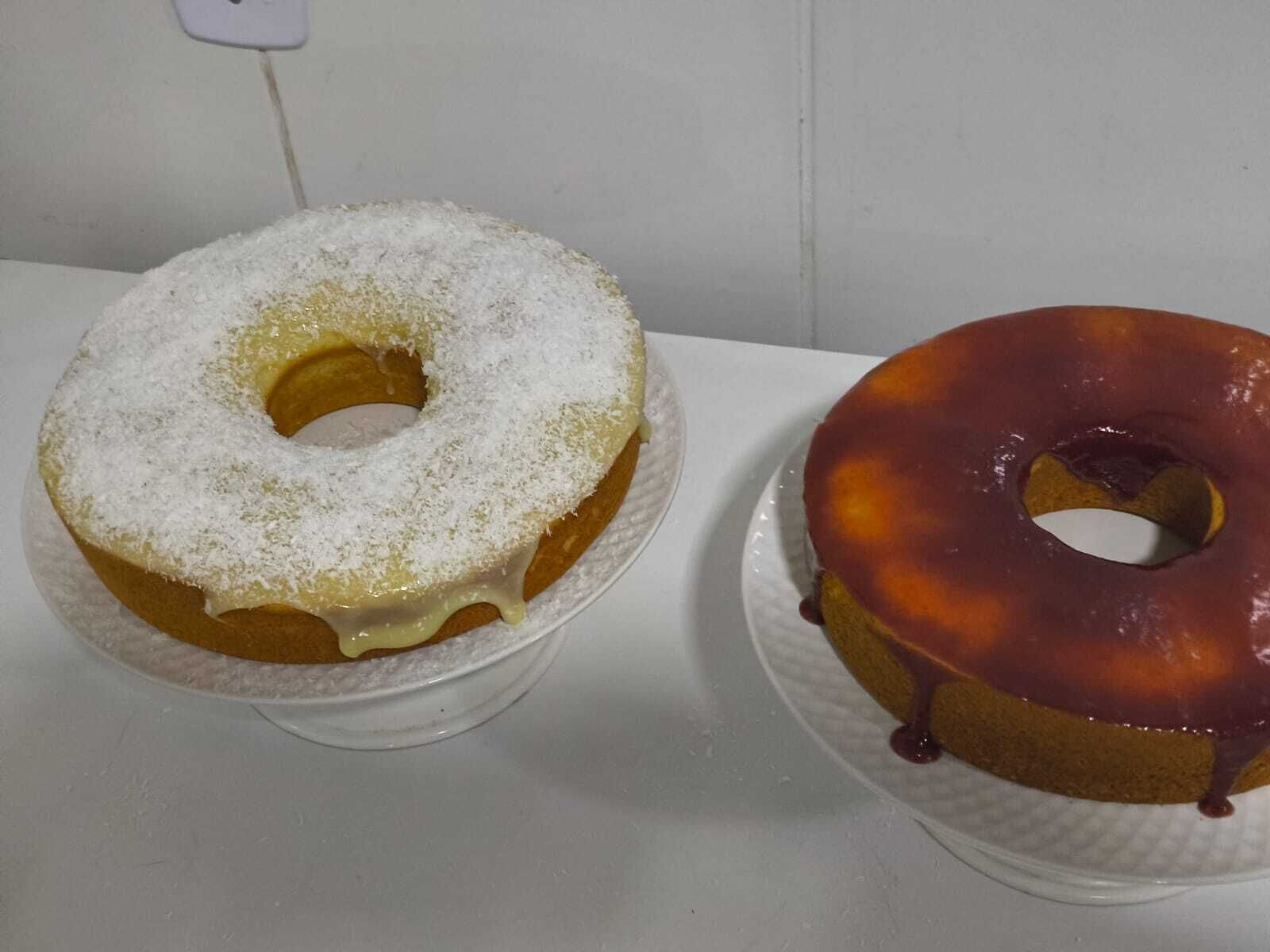 Two donuts on white plates.