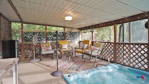 A covered outdoor area with a hot tub, seating, and a TV. - Tournament Ready Stay •Close to Parks •3 bedroom/2 bath •Pool/HotTub (College Station)