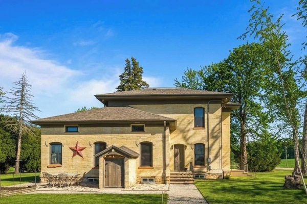 Front exterior | Historic 1868 Johnston Farmhouse near Kettle Moraine in East Troy, WI — Italianate architecture, mature trees, country privacy for weddings, family gatherings, and farm-style