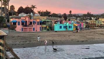 A beachfront with colorful buildings and a sandy beach.