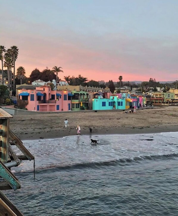 A beachfront with colorful buildings and a sandy beach.