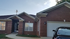 A two-story brick house with a garage, a driveway, and a parked car. -  One level ranch home.
Close to lake and park,bicycle lane, walking trail . (Knoxville)