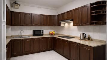 Microwave, stovetop, electric kettle, dining tables