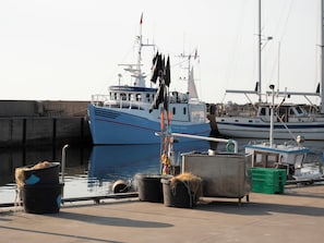 A harbor with boats docked, including a blue fishing vessel named 'Hanne Christina.' - Lovely holiday home with direct sea view (Glesborg)