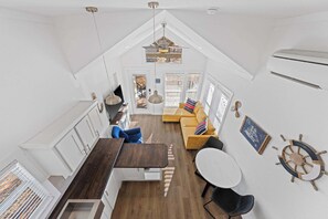 A compact, modern interior with a kitchen, dining area, and seating space. - The Resort at Fredericksburg Unit 28 (Fredericksburg)
