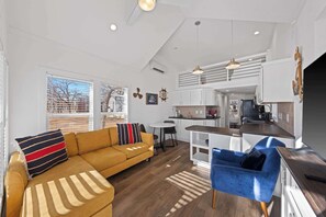 A modern apartment with a living area, kitchen, and dining space. - The Resort at Fredericksburg Unit 28 (Fredericksburg)