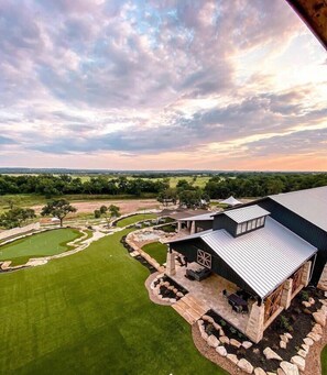 A modern house with a large deck, a swimming pool, and a well-maintained lawn. - The Resort at Fredericksburg Unit 24 (Fredericksburg)