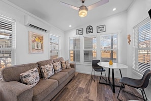 A living room with a sofa, two chairs, a small table, and a ceiling fan. - The Resort at Fredericksburg Unit 25 (Fredericksburg)