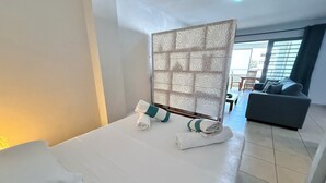 Ett hotellrum med en säng, en soffa och utsikt över omgivningarna.