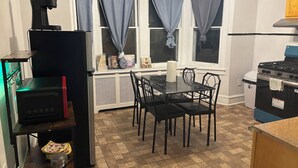 A compact kitchen with a dining table and chairs, a built-in oven, and a coffee machine. - 2bedroom, No living room, EinsteinHospital & Salus University (Philadelphia)