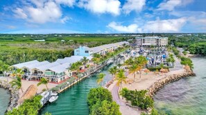 A coastal hotel with a marina, waterfront rooms, and a beach area. - Sunset, Large, Top Floor OceanFront Views, Island Condo - Key Largo (Key Largo)