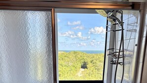 A bathroom with a glass door, a bathtub, and a shower. - Sunset, Large, Top Floor OceanFront Views, Island Condo - Key Largo (Key Largo)