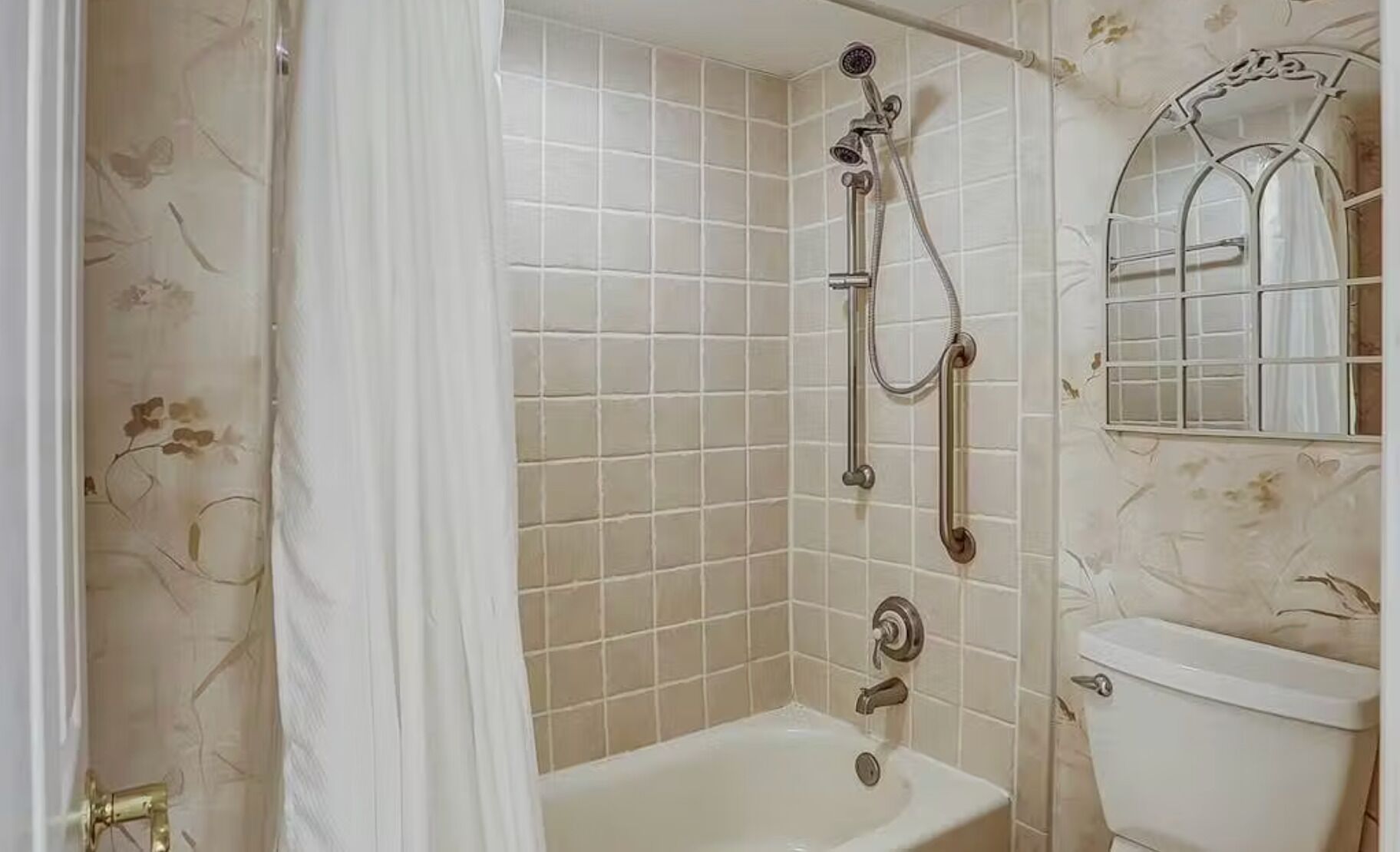A bathroom with a shower, toilet, and sink.