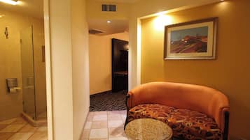 Deluxe Room | Living area | 55-inch Smart TV with cable channels