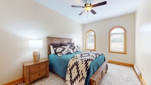 A bedroom with a bed, nightstand, lamp, and a ceiling fan. - Ground Floor | Fireplace | Master en-suite | Grande 116 (Angel Fire)
