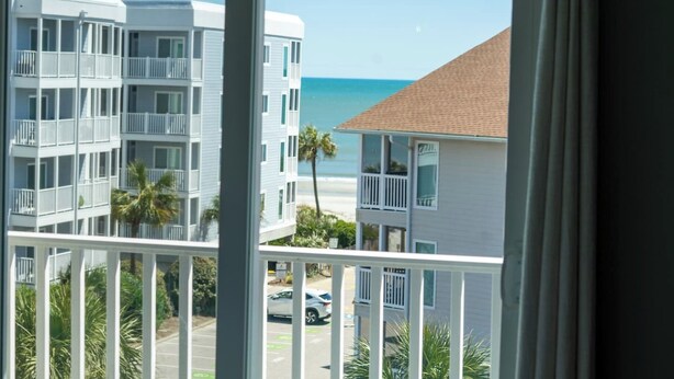A view of a multi-story building with balconies overlooking a beach. - Myrtle Beach Pelican's Watch Shore Drive Condo (Myrtle Beach)