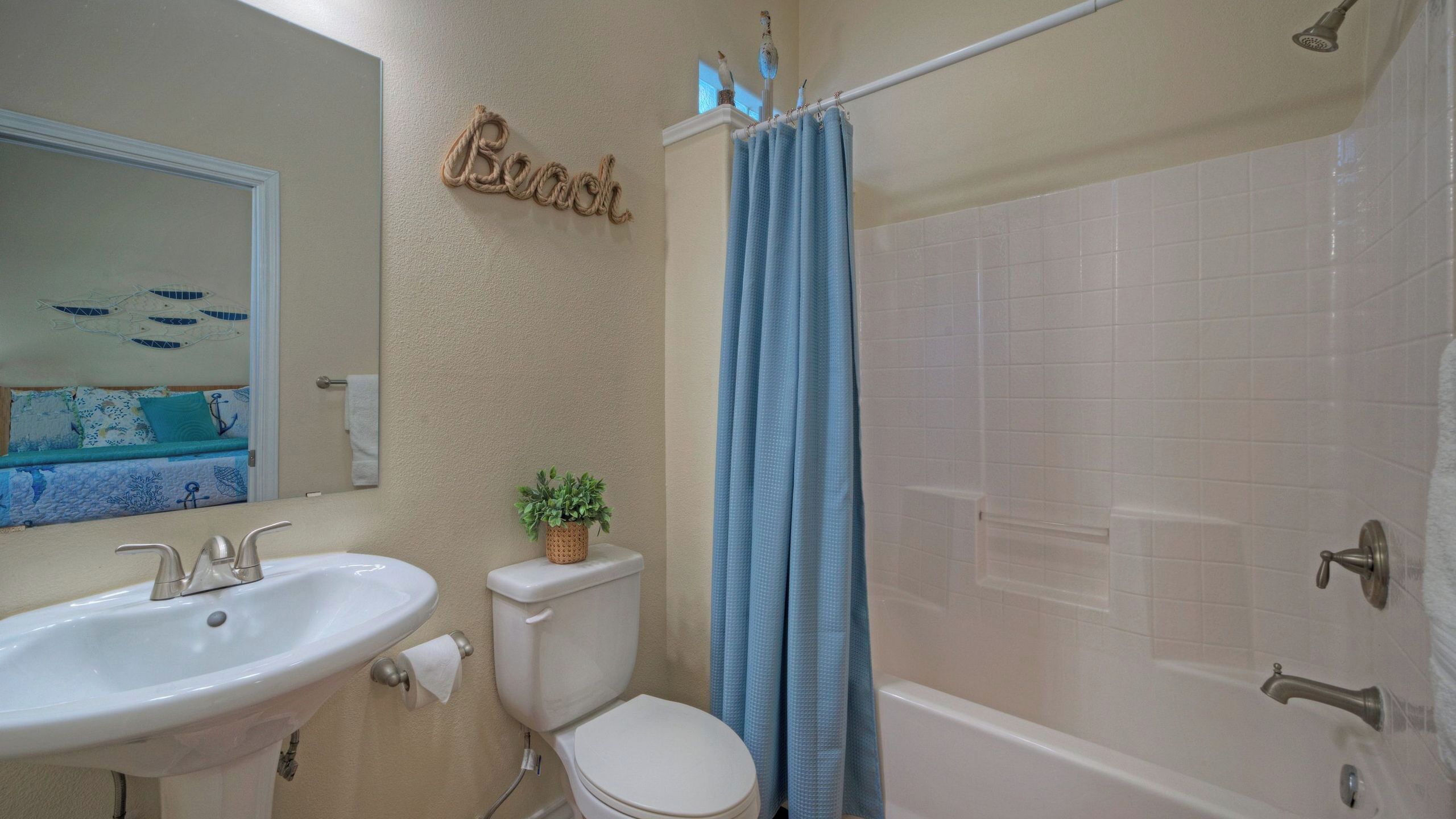 A bathroom with a sink, toilet, and bathtub.