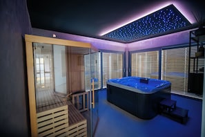 A modern spa room with a hot tub, wooden deck, and large windows with blinds. - Relaxation with pool and wellness in nature below Mount Ivančica (Ivanec)