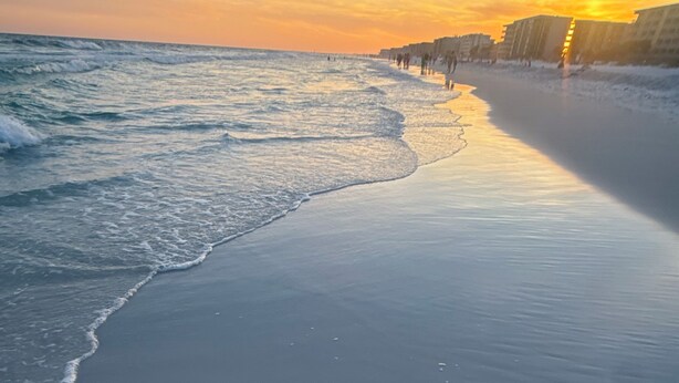 A beach with a calm sea, a clear sky, and buildings in the background. - CASABELLA,4bed/2bath, 8 min from beach/ w/ POOL (Fort Walton Beach)
