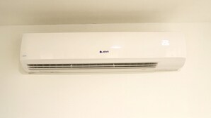 A white wall-mounted air conditioner with the brand name "ABONIX" visible. - Mami's LITTLE Corner - Near Airport, Beaches and Malls (San Juan)
