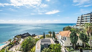 A coastal hotel with a pool, lush greenery, and a view of the sea. - Step To The Sea 5, by Pausa Holiday Rentals (Funchal)
