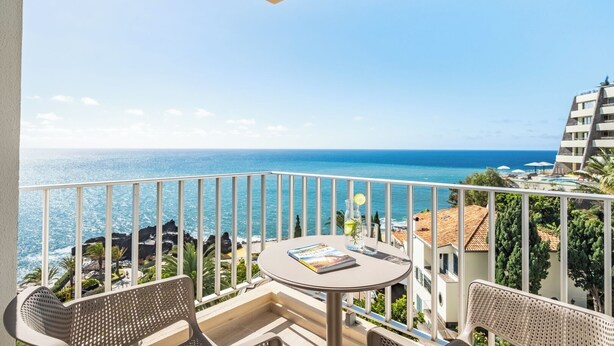 A balcony with a table, chairs, and a view of the sea. - Step To The Sea 5, by Pausa Holiday Rentals (Funchal)