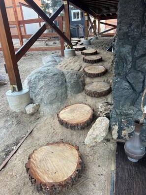 A wooden deck with stone steps and a metal lamp post. - Aspen Stone Lodge
High-end luxury mountain lodge in popular upper Moonridge. (Big Bear Lake)