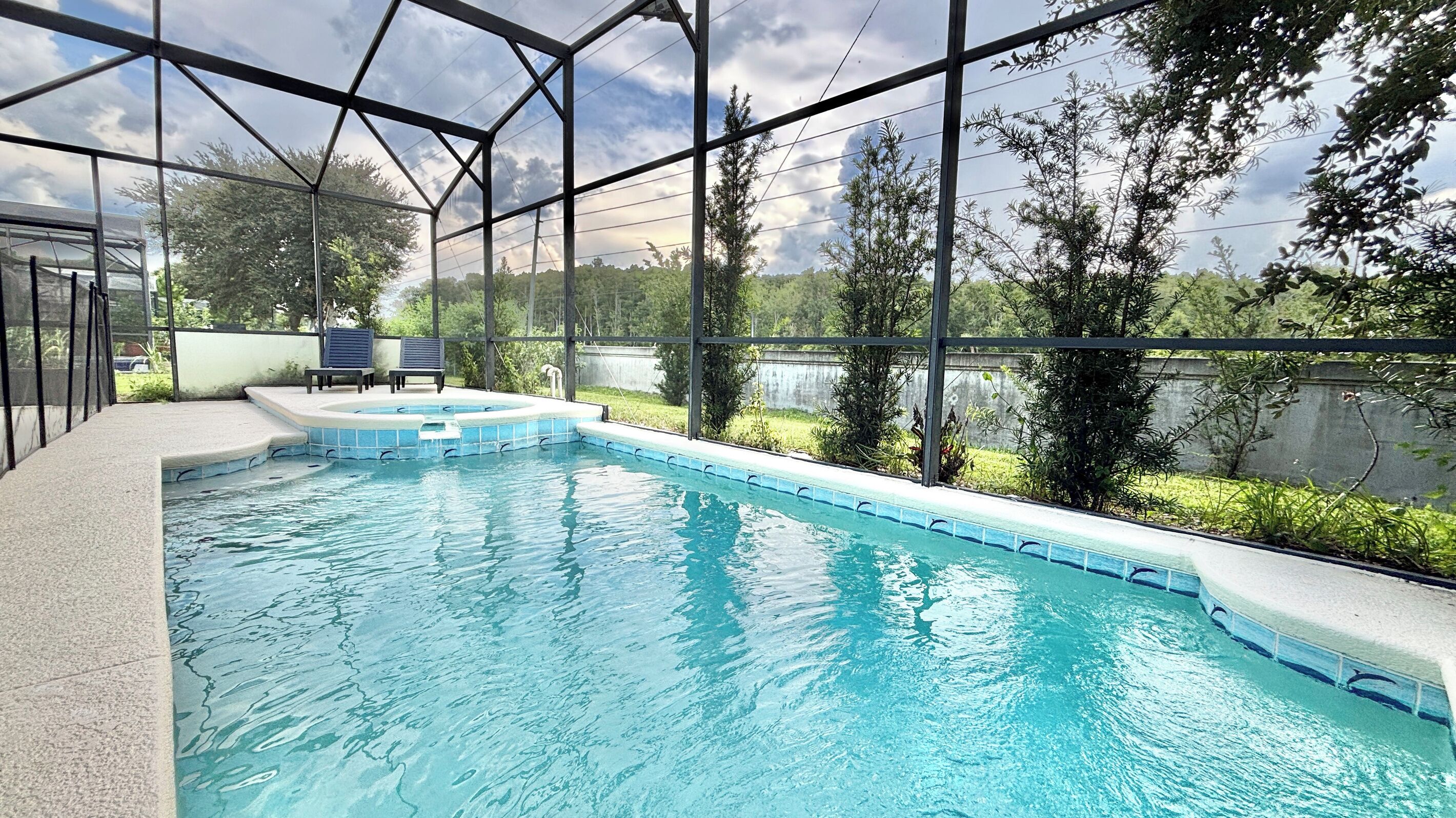 An indoor swimming pool with a view of the surrounding greenery.