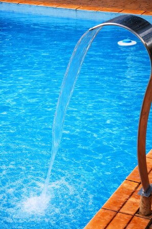 En tydlig vy över en swimmingpool med en vattenfontän.
