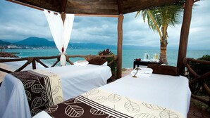 A beachfront room with two beds, a view of the sea, and a palm tree. - Beachside Studio Near Downtown Puerto Vallarta (Puerto Vallarta)