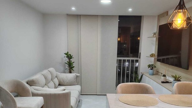 A modern living room with a sofa, chairs, and a wooden coffee table. - New apartment well located in a 4 floor brand new with all the comforts. (Barranquilla)