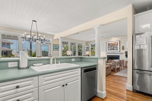 A modern kitchen with a dishwasher, a sink, and a stainless steel refrigerator. - Oceanfront, 2nd Row Bald Head Island (Bald Head Island)