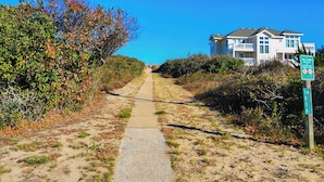 A pathway leading to a beach with a sign indicating '180 A Ocean Blvd Beach Access'. - Absolute Paradise -  4 BR Oceanside Home w/Private Pool, 105 Yards to Beach Access (Southern Shores)