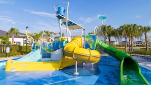 A water park with multiple slides and water features, surrounded by palm trees and buildings. - Family Villa Private Pool Spa Arcade Sleeps 22 (Davenport)