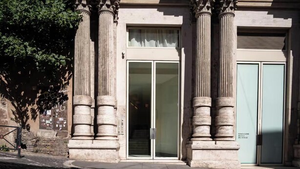 Un b âtiment doté de colonnes de style classique, d’une entrée avec une porte en verre et d’une enseigne indiquant une fondation nommée « Nicola del Roscio ».