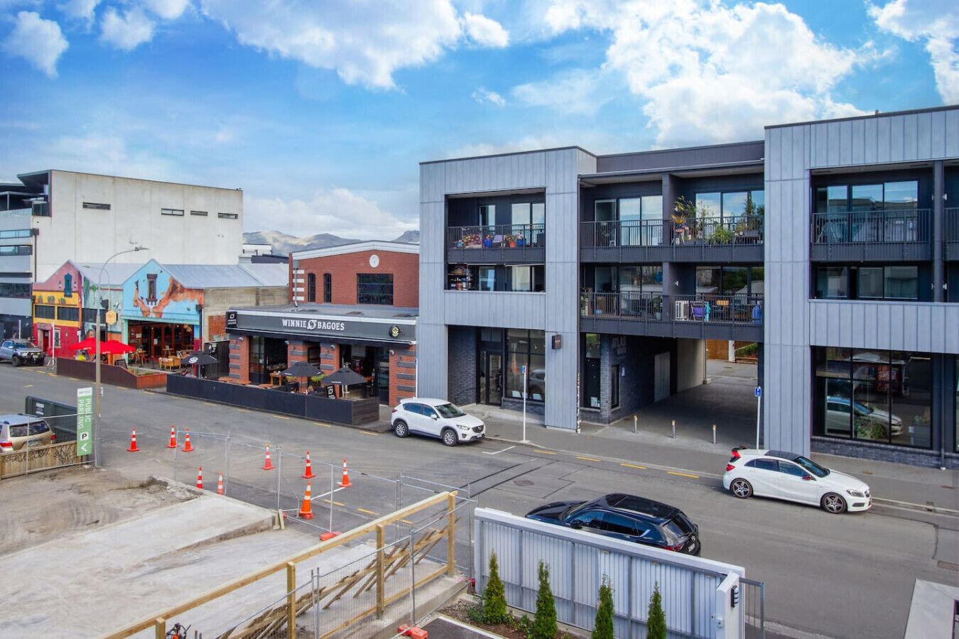A modern building with a ground floor restaurant and upper commercial spaces.