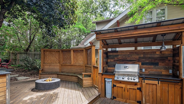 A wooden deck with a built-in grill and fire pit. - Walk to Fox River Grove Train Station + Hot Tub! (Fox River Grove)