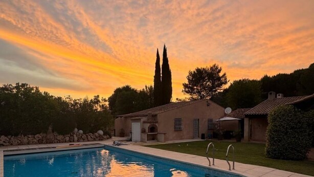 A swimming pool with a clear view of the sky and surrounding buildings. - La Maisonnette by Interhome (Le Val)