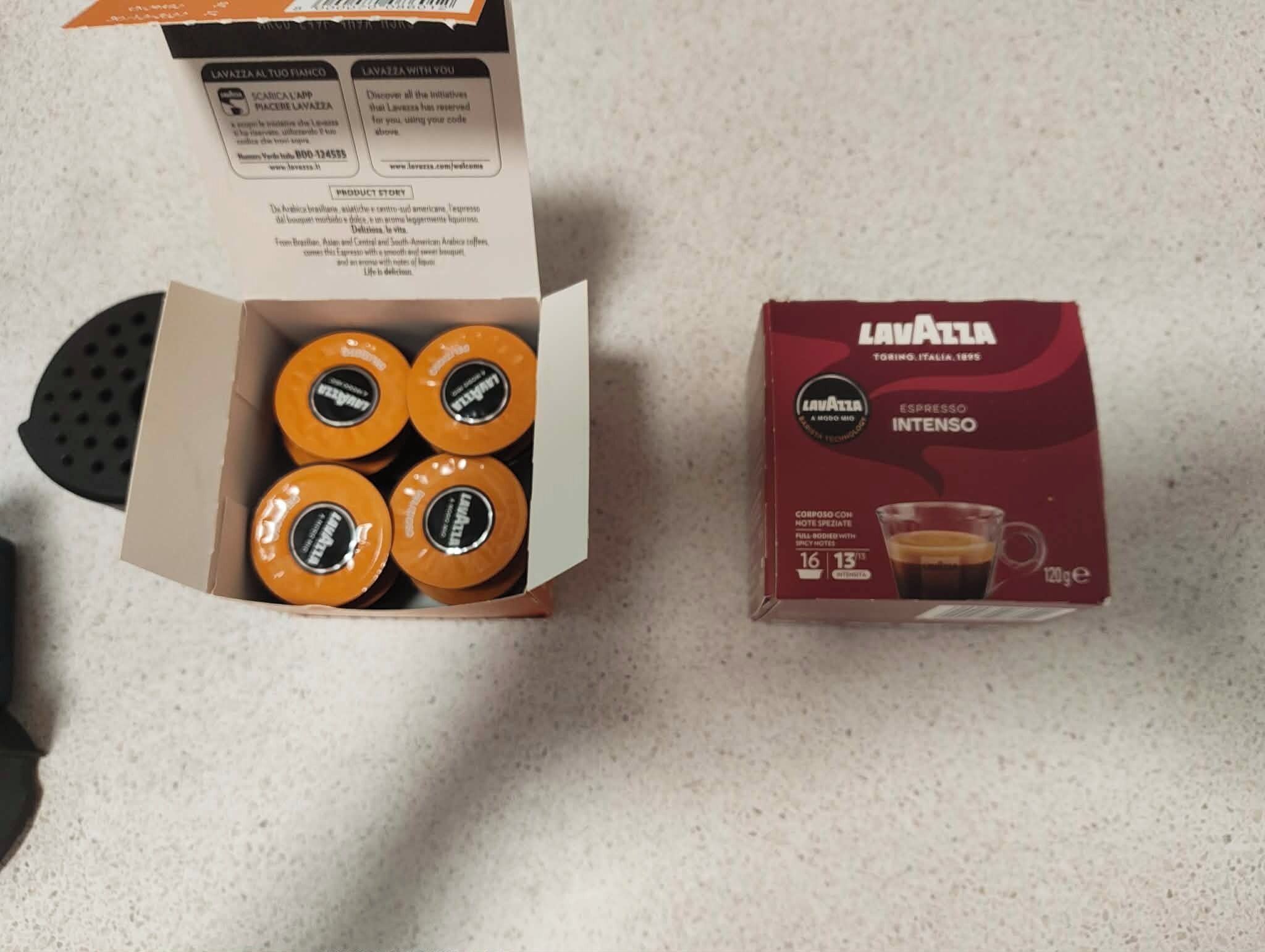 A box of Lavazza espresso coffee pods and a coffee maker.