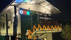 A building with a sign reading "ome" and "CAFE DELHI 34". - Down Valley Resort (Rishikesh)