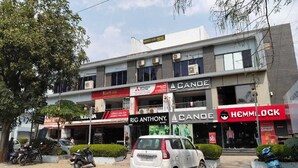 A multi-story building with various shops including 'Hotel Lee Prime', 'Kurt-on', 'Rig Anthony', 'ACANE', and 'Hemlock'. - Hotel Lee Prime (Ahmedabad)