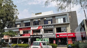 Un edificio de varios pisos con diversos comercios, incluyendo un hotel llamado "Hotel Ice Prime" en el último piso.