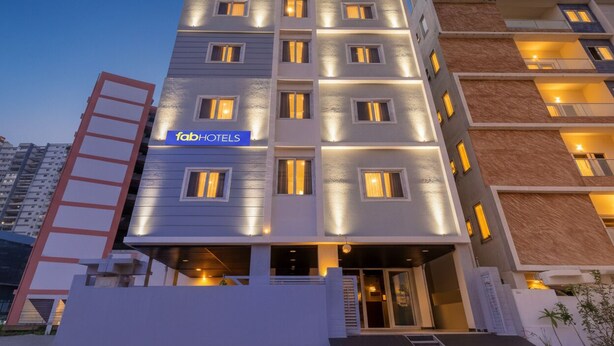 A modern multi-story hotel with a prominent 'fab-hotels' sign, multiple balconies, and a well-lit entrance. - Fabhotel High Rise Kokapet (Hyderabad)