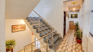 A staircase with metal railings leading to a landing. - Fabhotel Dream Sky (Pune)